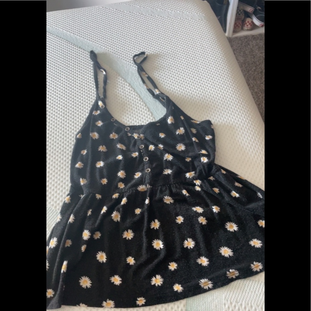 Black skinny strap tank with sunflowers.sewn in band across torso.